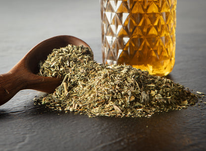 Picture of loose leaf tea next to glass of tea. 