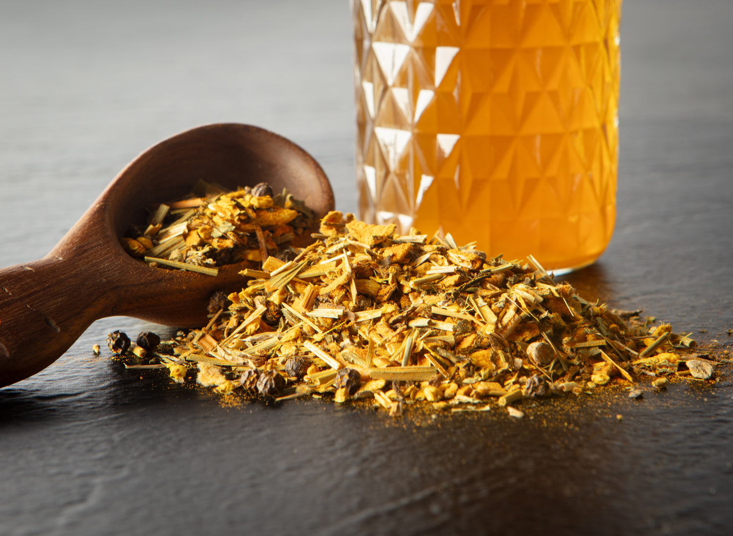 Picture of loose leaf tea next to glass of tea. 